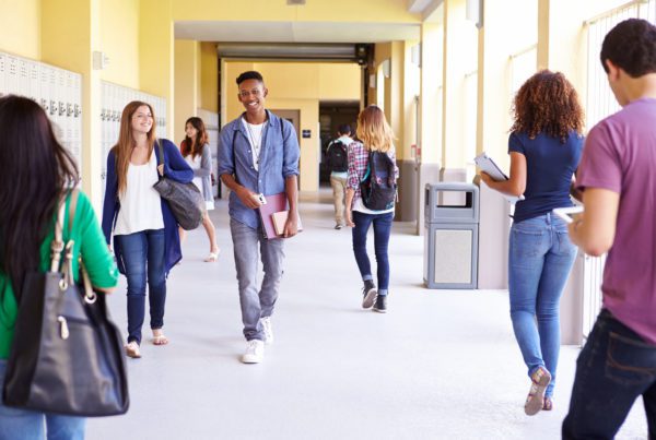 Students walking down a school hallway showing the importance of school safety