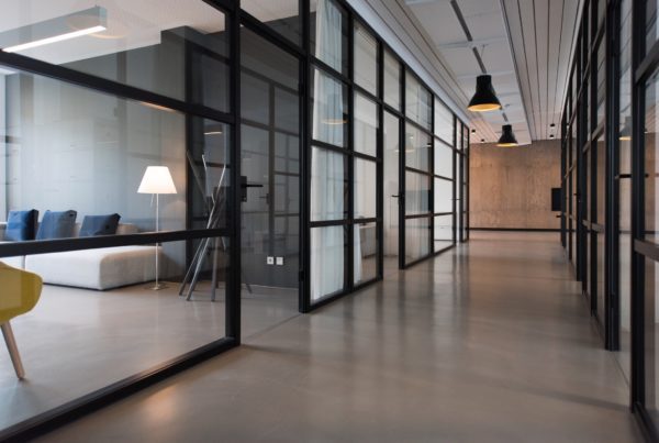 Hallway looking is to offices with glass windows with smart window film