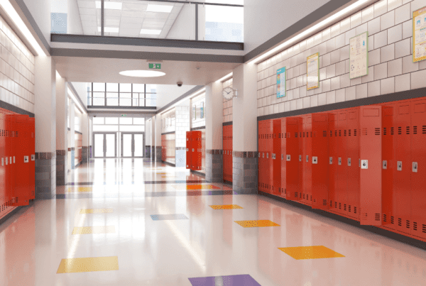empty school halfway lined with red lockers and colored floors